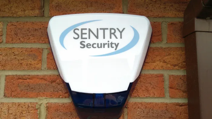 Sentry Security external alarm sounder installed on a brick wall